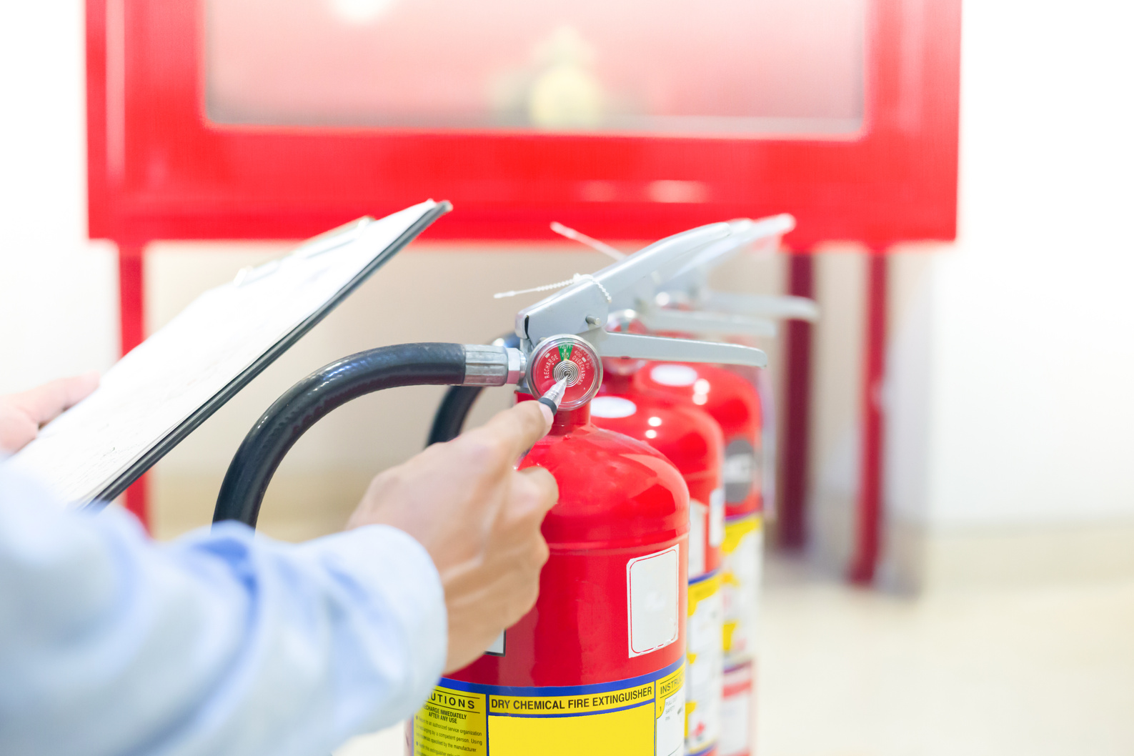 Expert engineers inspect fire extinguishers to be ready for use.